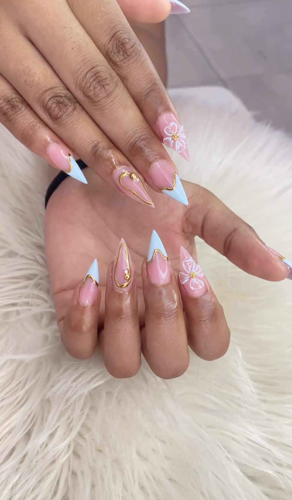 Baby blue French tips with gold and white daisy nail art