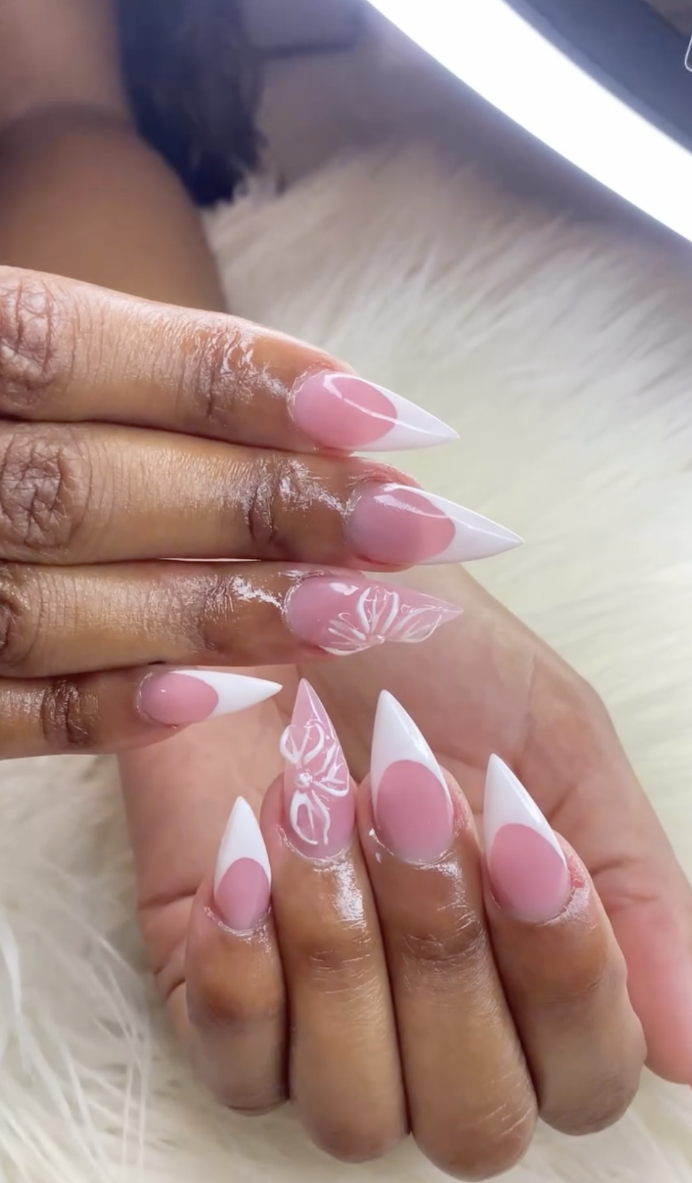 Pink French nails with white butterfly nail art