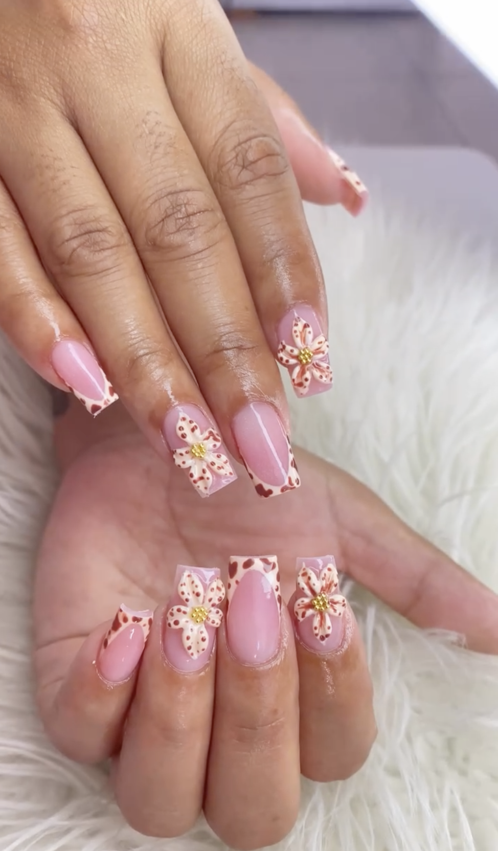 Pink nails with gold and white flower nail art
