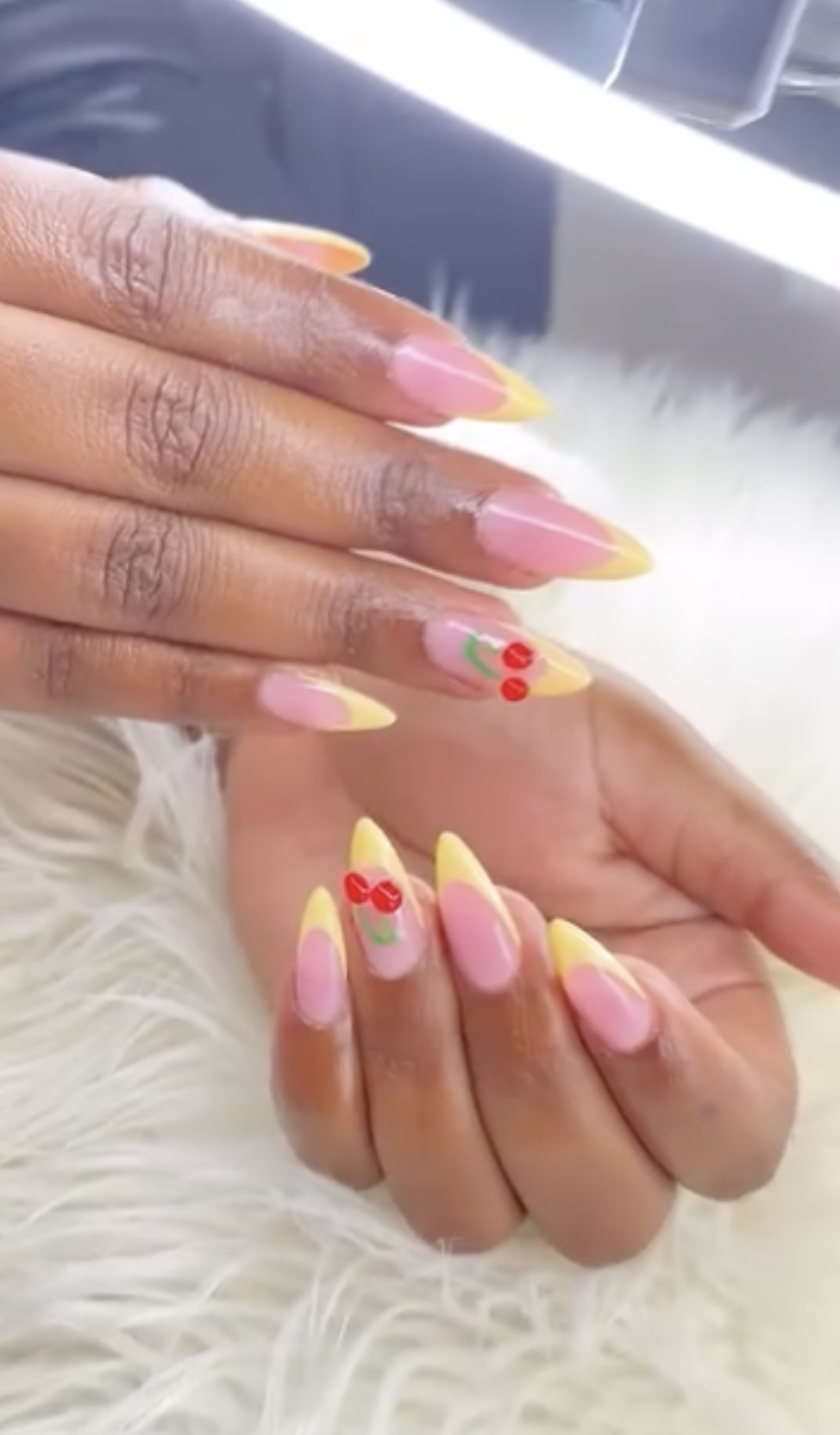 Pink and yellow ombre nails with cherry nail art