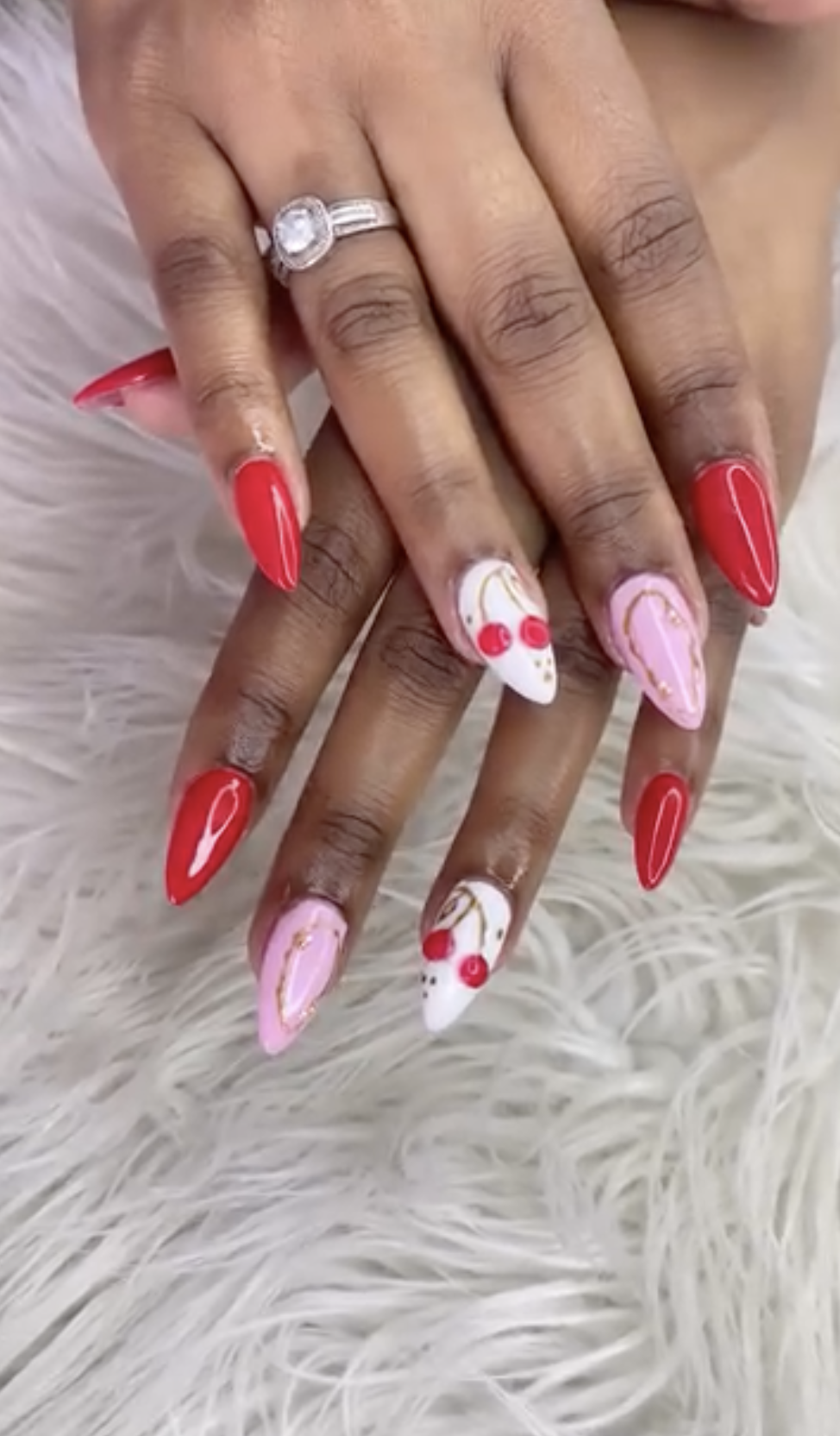 Red nails with cherry and heart nail art